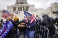 Rioters try to break through a police barrier at the Capitol in Washington on Jan. 6, 2021.
