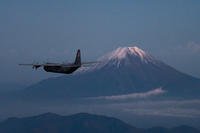 A Super Hercules aircraft assigned to the 36th Airlift Squadron flies past Mount Fuji in Japan after executing a bilateral airborne jump.