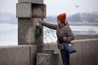 A woman pays last respects to Alexei Navalny.