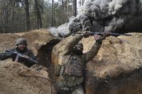 Ukrainian National guard soldiers simulate assault operations during tactical training at a shooting range in Kharkiv region, Ukraine