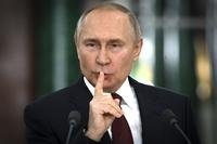 Russian President Vladimir Putin gestures while speaking at a news conference