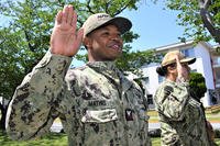 ABF1 Cedric Mathis (left), assigned to NAVSUP FLC Yokosuka Fuels Department, and his wife, ABF1 Aleesha Mathis (right) of USS Ronald Reagan (CVN-76), take an oath of enlistment during a reenlistment ceremony in Japan.