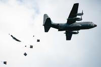 U.S. Army paratroopers assigned to the 54th Brigade Engineer Battalion (Airborne) secure a drop zone for an aerial humanitarian aid package delivery from a C-130 Hercules aircraft during a joint airborne operation with Serbian special operations paratroopers from the 63rd Parachute Brigade as part of Exercise Skybridge 21 at the Medja Training Area in Niš, Serbia.