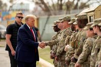 Republican presidential candidate former President Donald Trump greets members of the National Guard