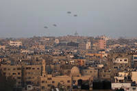 Humanitarian aid is dropped by the United States over Gaza City.