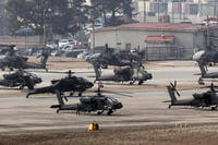 U.S. Army Apache helicopters take off at Camp Humphreys in Pyeongtaek, South Korea
