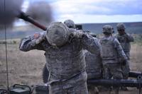 Oregon Army National Guardsman plugs his ears during a live fire mission
