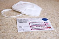 A Covid-19 identification card and mask.