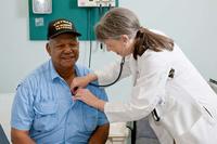 A doctor uses a stethoscope to listen to the heart of a Vietnam Veteran (Photo: va.gov)