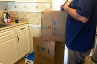 moving boxes in kitchen with mover