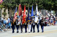 A joint services color guard leads off an annual Armed Forces Day parade (Photo: U.S. Air Force/Joe Juarez.)