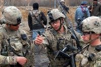 U.S. Army Capt. Joe Pazcoguin of the 4th Infantry Division (2nd from right) talks with 1st Lt. Austin Cattle (right) and 1st Lt. Mitchell Creel during a clearance operation in western Kandahar, Afghanistan, on Feb. 1, 2012. (U.S. Army)