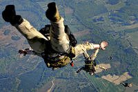 U.S. Air Force photo/Staff Sgt. Brian Ferguson. Navy SEALs make a practice jump.