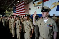 FILE -- Newly-pinned chief petty officers recite the Chief Petty Officer’s Pledge in the hangar bay of the aircraft carrier, USS Ronald Reagan. (U.S. Navy/Ryan N. McFarlane)