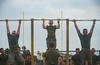 Marines perform pull-ups during physical fitness test.