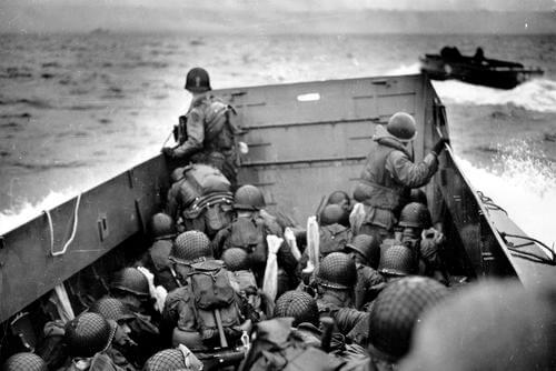 An officer observes Omaha as his landing craft approaches the Normandy coast. (Photo: National Archives)