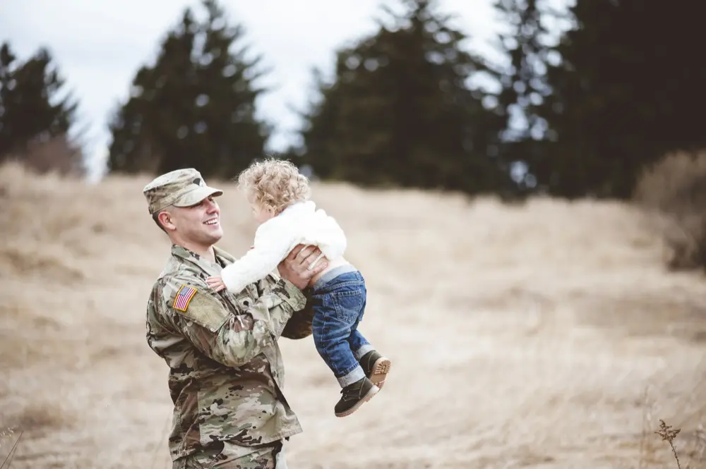 military member holding child